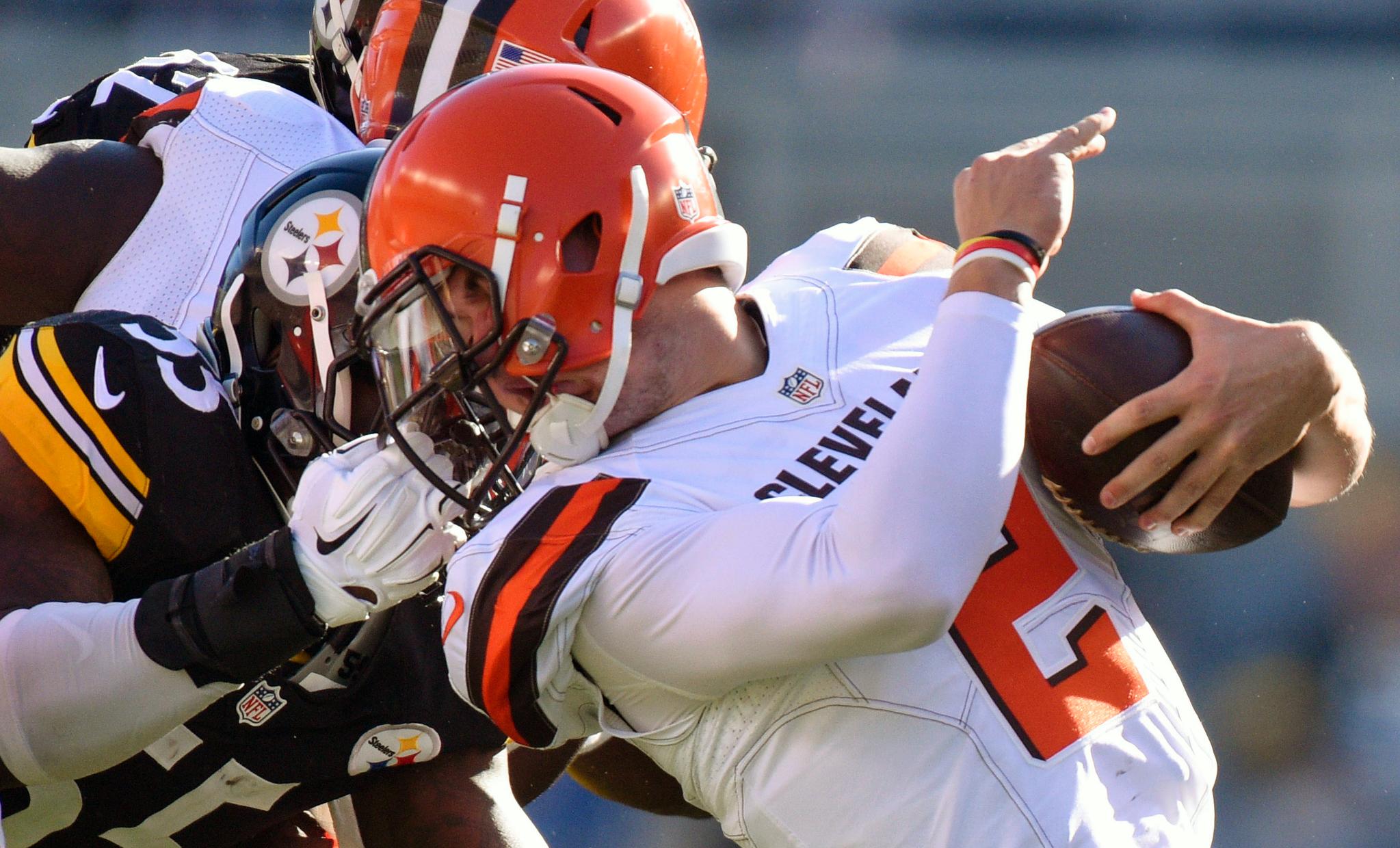 A player grabs the facemask of an opponent